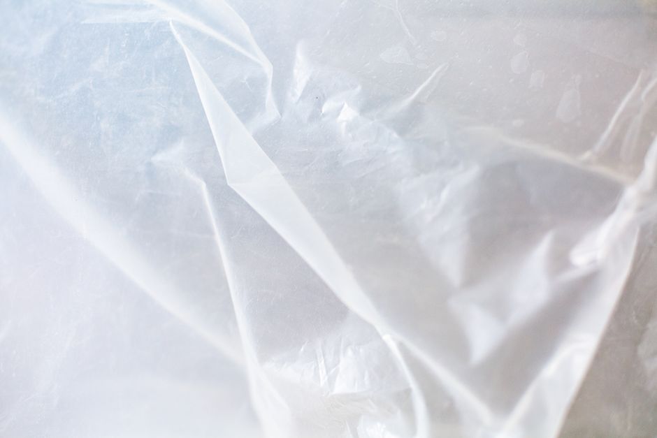 Clear plastic sheeting like the vapor barrier that should cover the soil in a sealed crawl space.